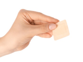 Photo of Woman holding medical adhesive bandage on white background, closeup