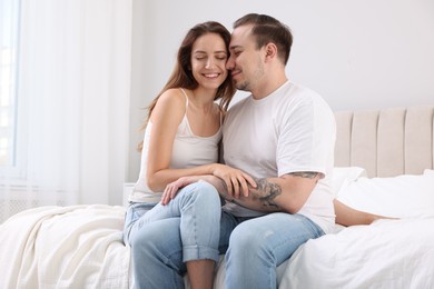 Happy couple spending time together on bed at home