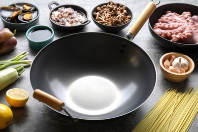 Photo of Ingredients for wok on grey table, closeup