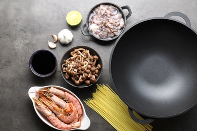 Photo of Ingredients for wok on grey table, flat lay