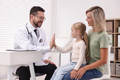 Mother and her little daughter having appointment with doctor in hospital