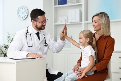 Mother and her little daughter having appointment with doctor in hospital