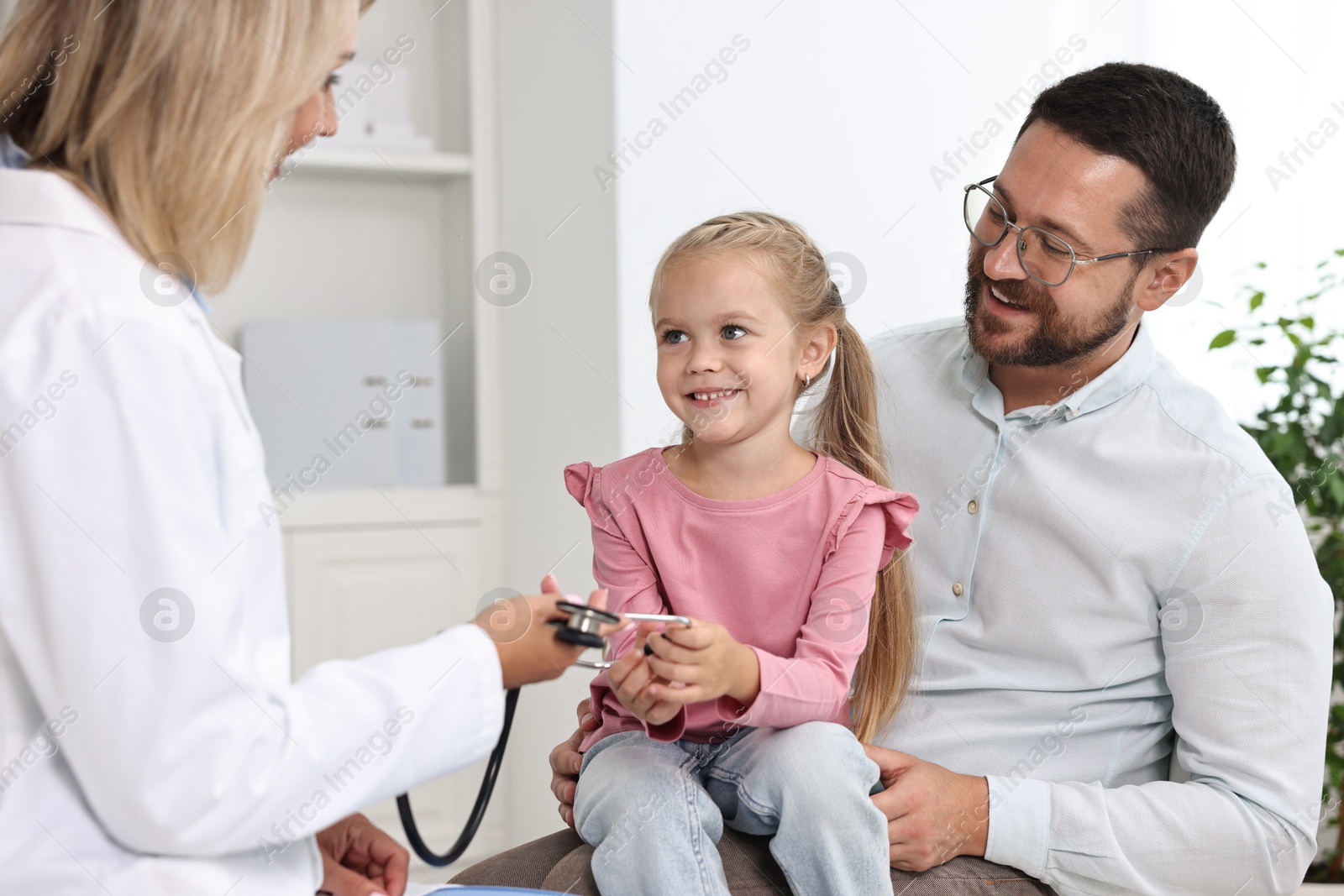 Photo of Father and her little daughter having appointment with doctor in hospital