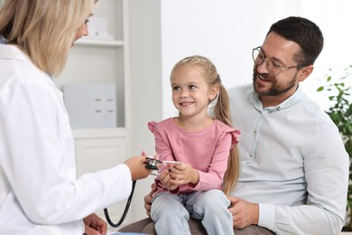 Father and her little daughter having appointment with doctor in hospital