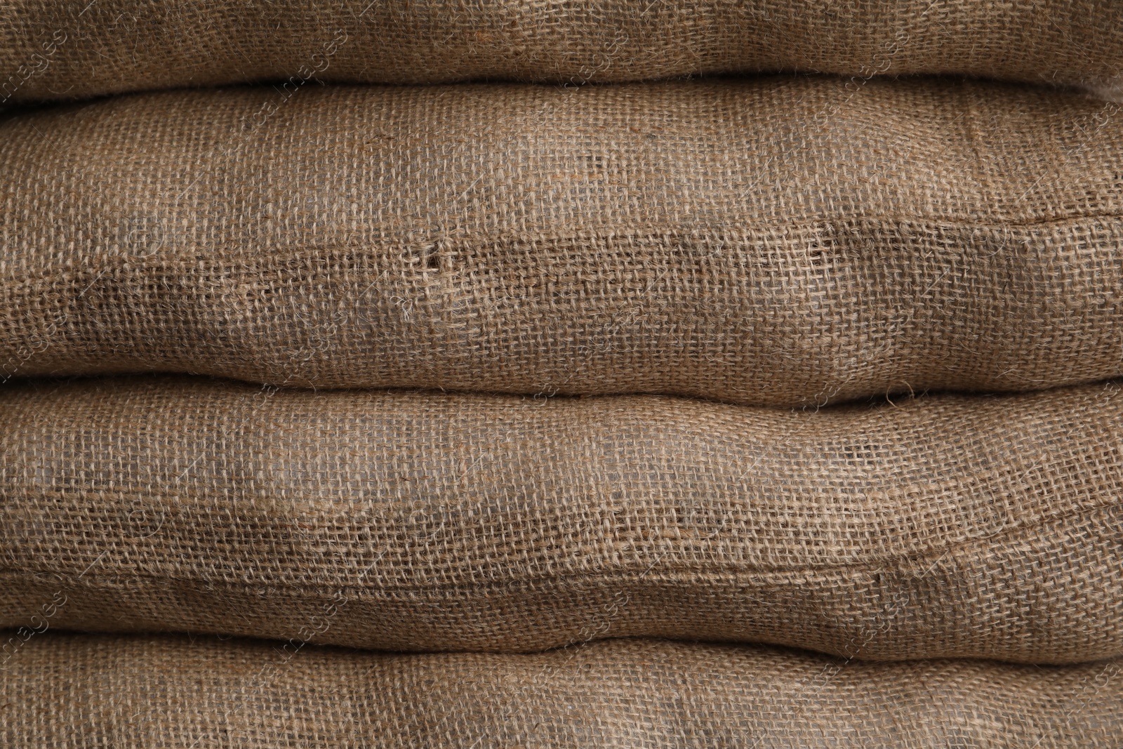 Photo of Group of burlap sacks as background, closeup