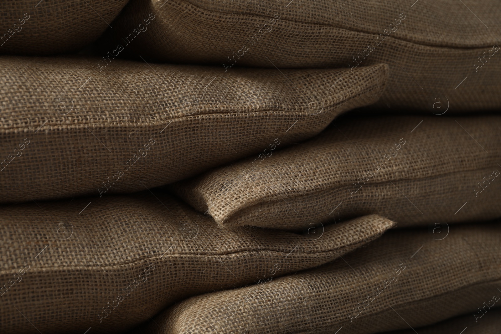 Photo of Group of burlap sacks as background, closeup