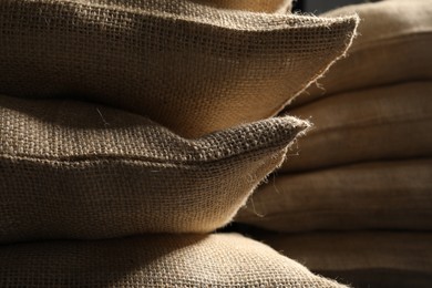 Photo of Closeup view of many natural burlap sacks