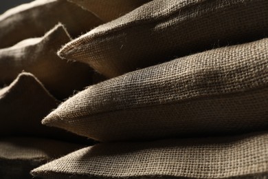 Photo of Closeup view of many natural burlap sacks