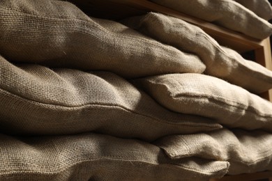 Photo of Group of burlap sacks on shelving unit, closeup