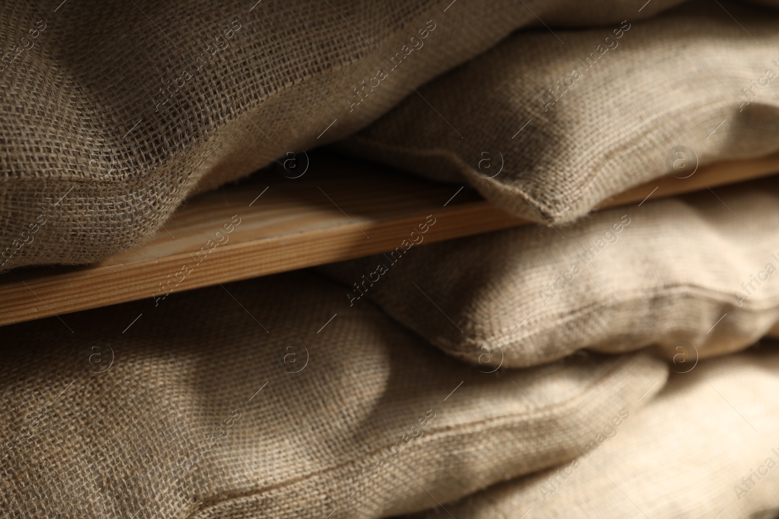 Photo of Group of burlap sacks on shelving unit, closeup