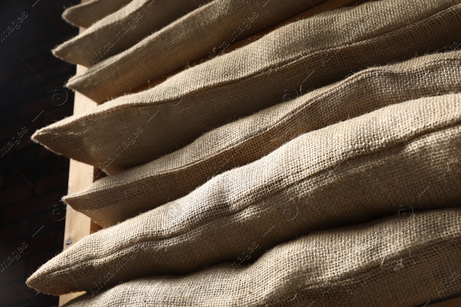 Photo of Group of burlap sacks on shelving unit, closeup