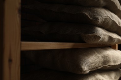 Photo of Group of burlap sacks on shelving unit, closeup