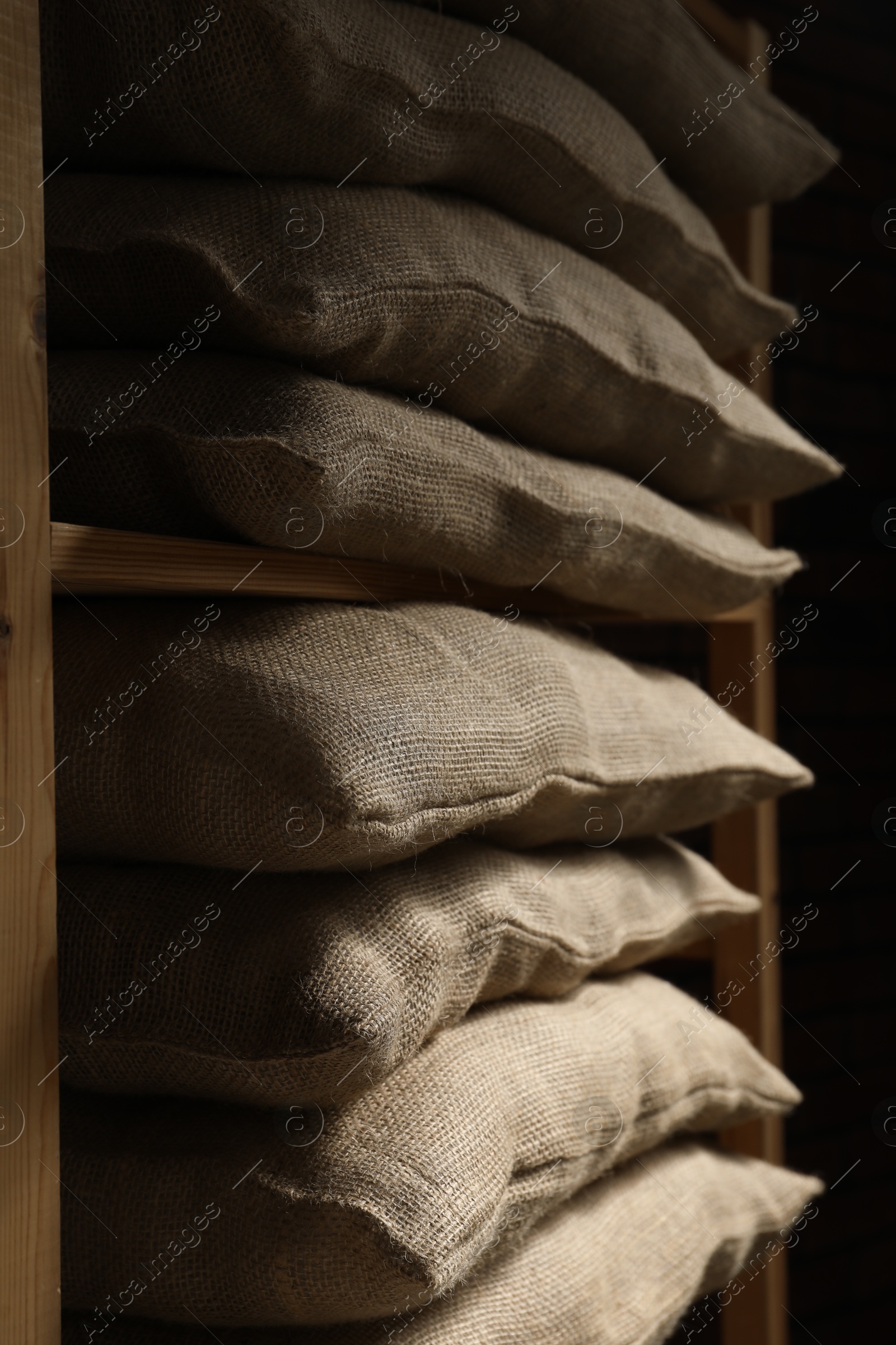 Photo of Group of burlap sacks on shelving unit, closeup