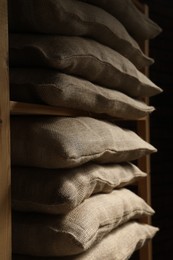 Group of burlap sacks on shelving unit, closeup