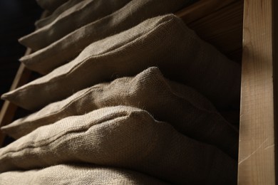 Group of burlap sacks on shelving unit, low angle view