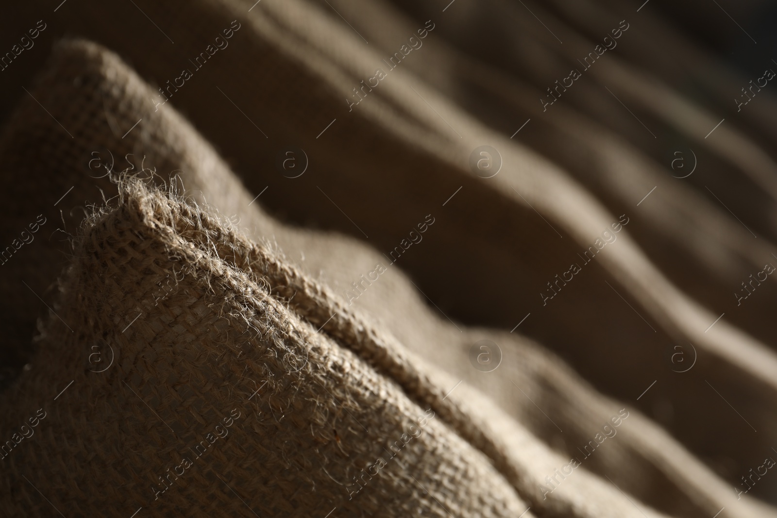 Photo of Closeup view of many natural burlap sacks