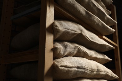 Group of burlap sacks on shelving unit