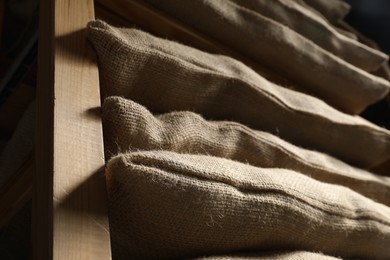 Photo of Group of burlap sacks on shelving unit, low angle view