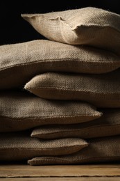 Group of burlap sacks on wooden table