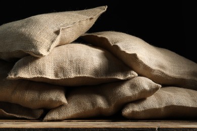 Photo of Group of burlap sacks on wooden table