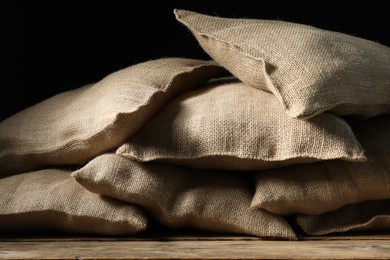 Photo of Group of burlap sacks on wooden table