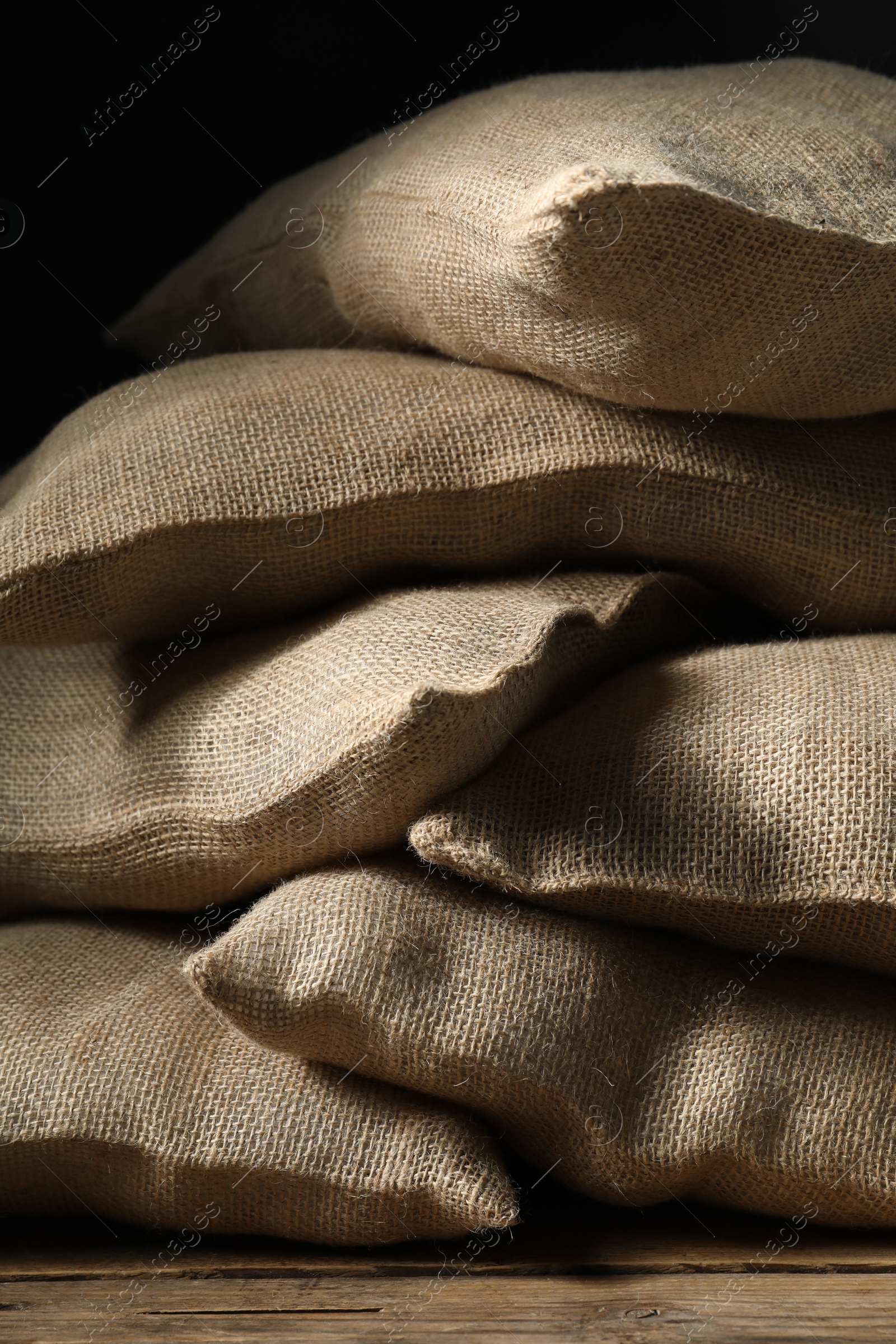 Photo of Group of burlap sacks on wooden table