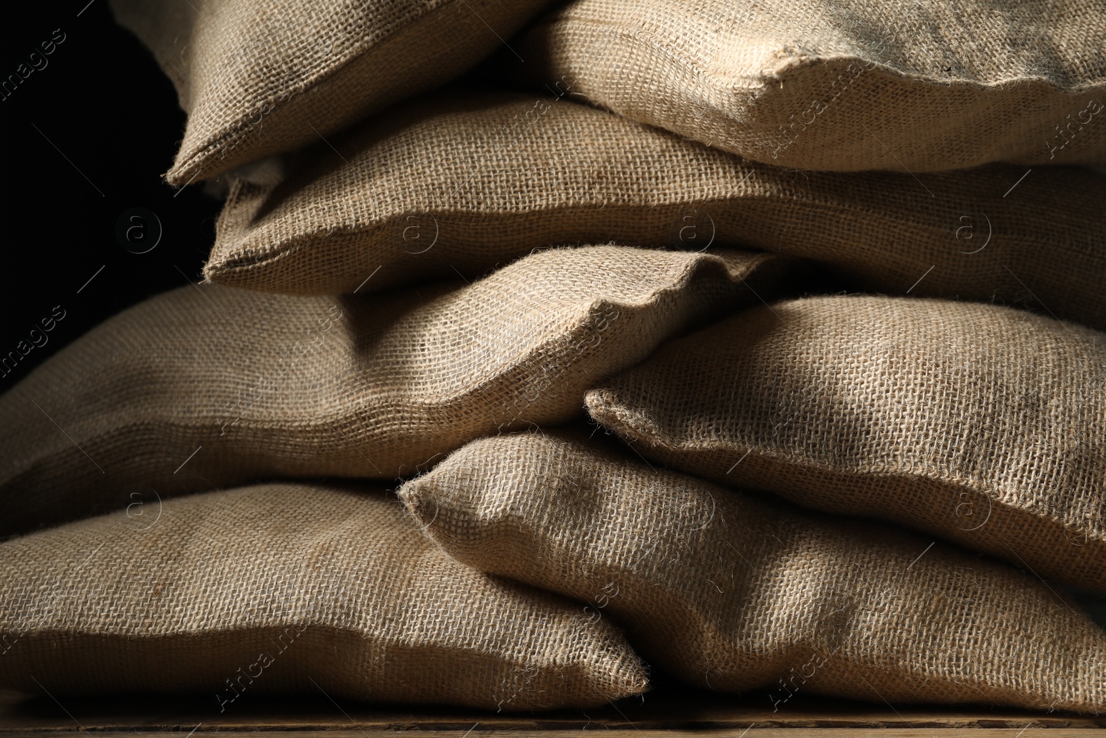 Photo of Group of burlap sacks on table, closeup