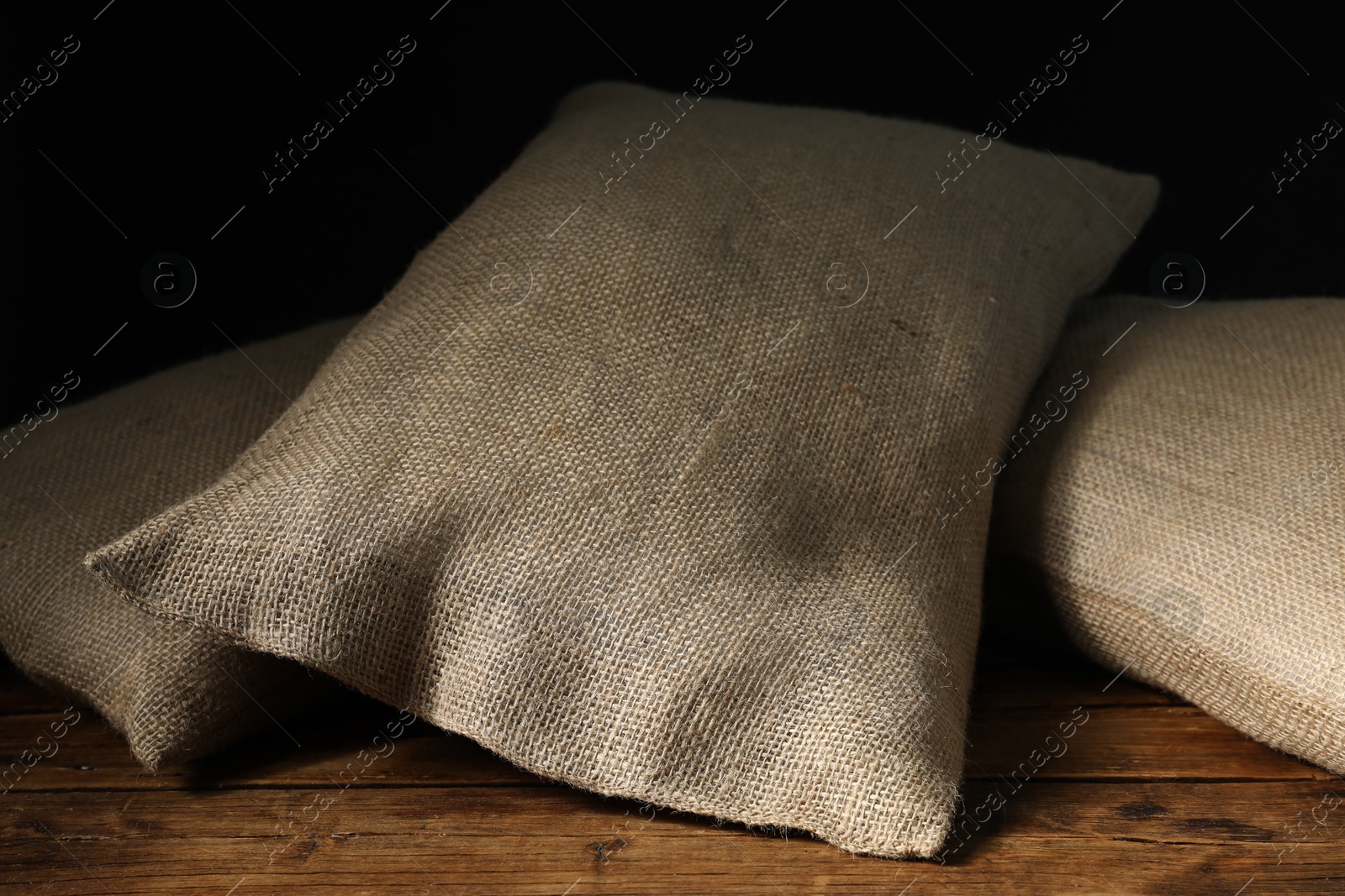 Photo of Group of burlap sacks on wooden table