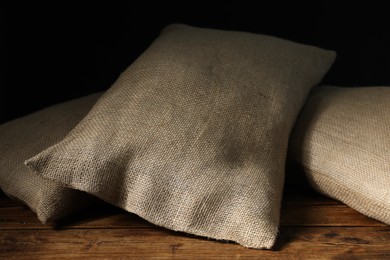 Group of burlap sacks on wooden table