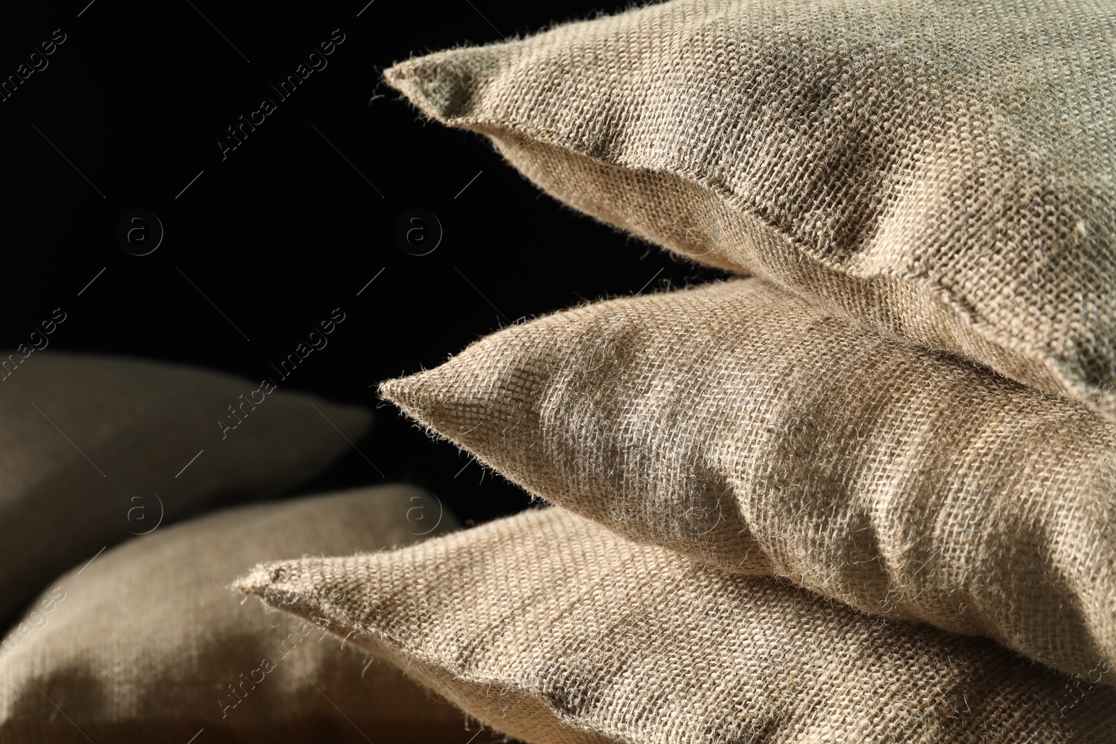 Photo of Group of burlap sacks on table, closeup