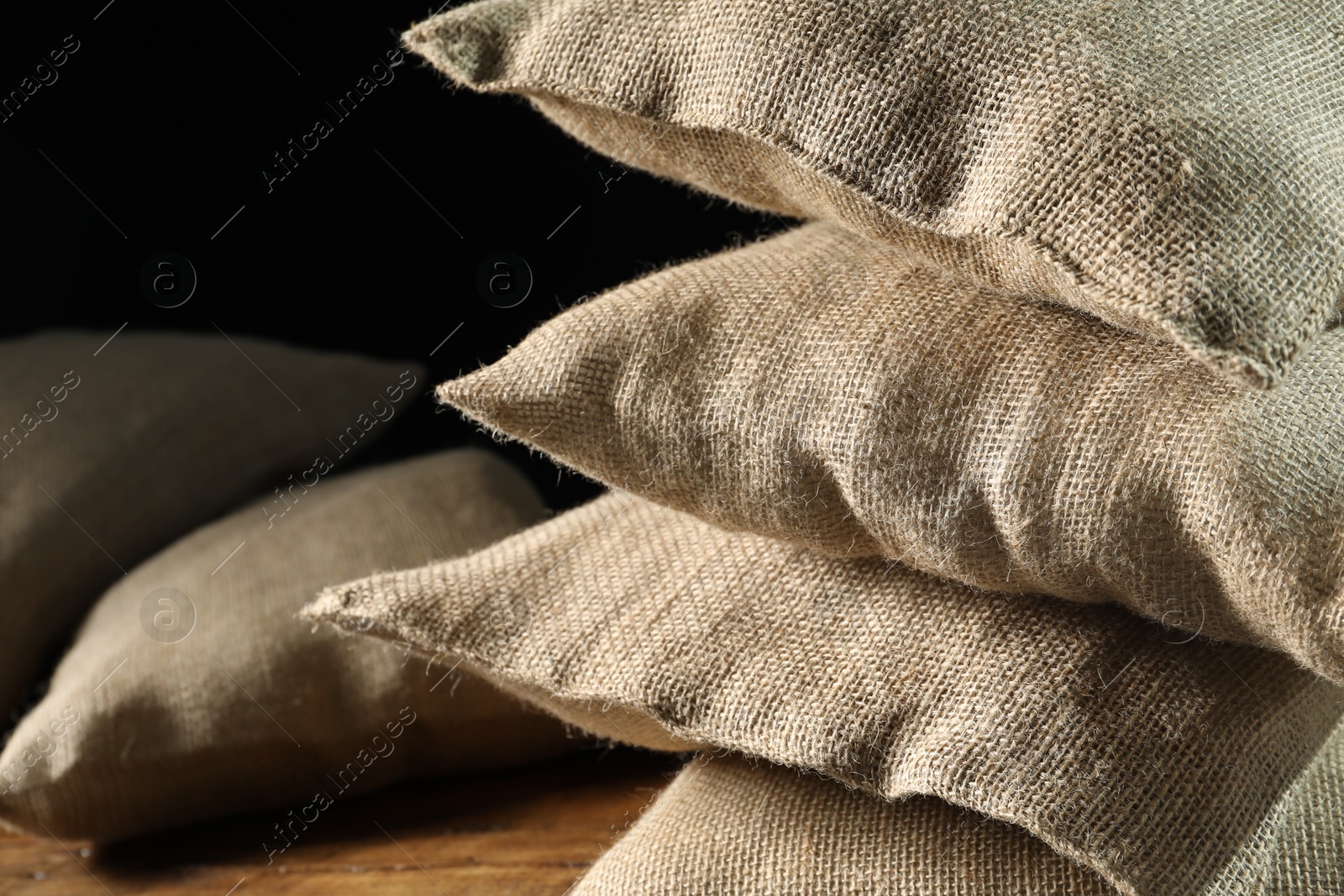 Photo of Group of burlap sacks on table, closeup