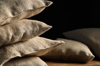 Photo of Group of burlap sacks on table, closeup