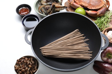 Different ingredients for wok on white table