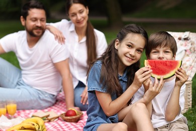 Photo of Family picnic. Parents and their children spending time together outdoors, selective focus