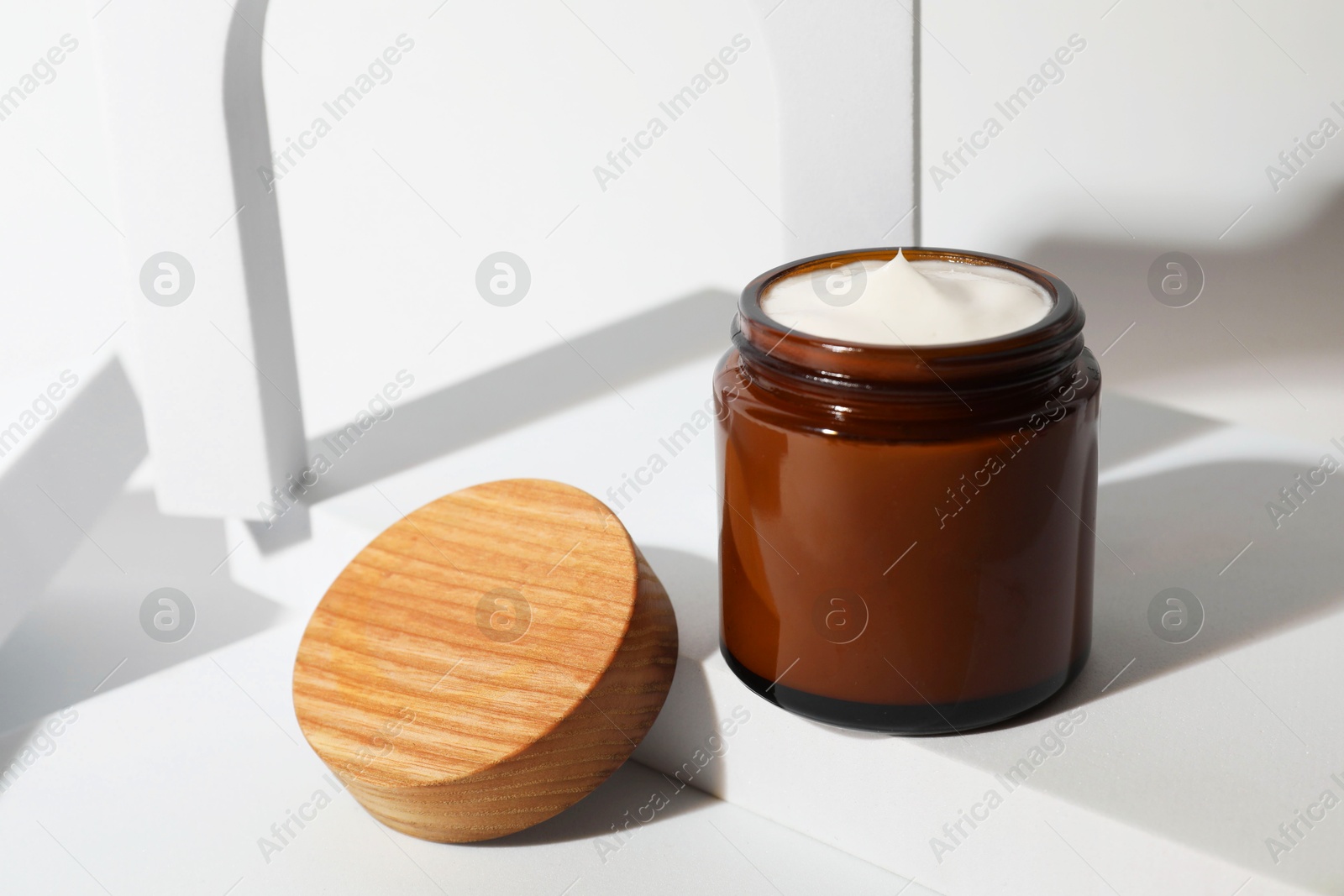 Photo of Stylish presentation of facial cream on white background, closeup