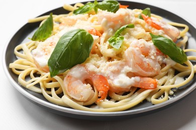 Photo of Tasty pasta with shrimps on white table, closeup