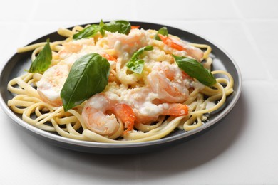 Photo of Tasty pasta with shrimps on white table, closeup