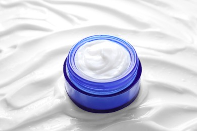 Face cream in jar on cosmetic product, closeup