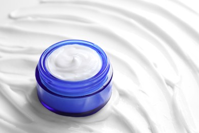 Photo of Jar with face cream, closeup. Space for text