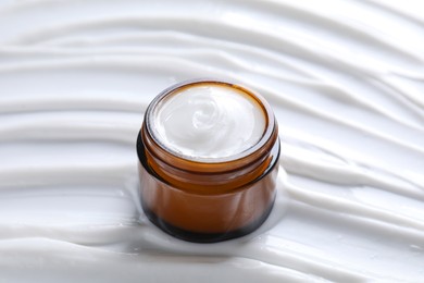 Face cream in jar on cosmetic product, closeup