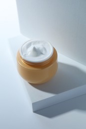 Photo of Face cream in jar on white background. Cosmetic product