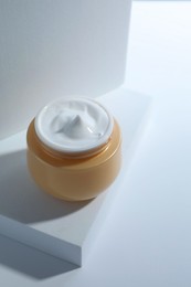 Face cream in jar on white background. Cosmetic product