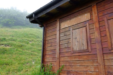 Photo of Beautiful wooden building with closed window in mountains