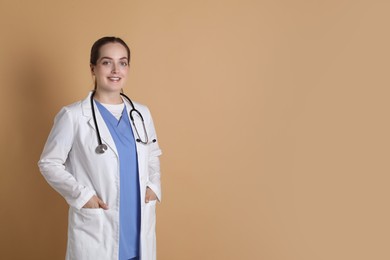 Photo of Portrait of professional nurse on dark beige background. Space for text