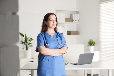 Portrait of professional nurse with stethoscope in clinic