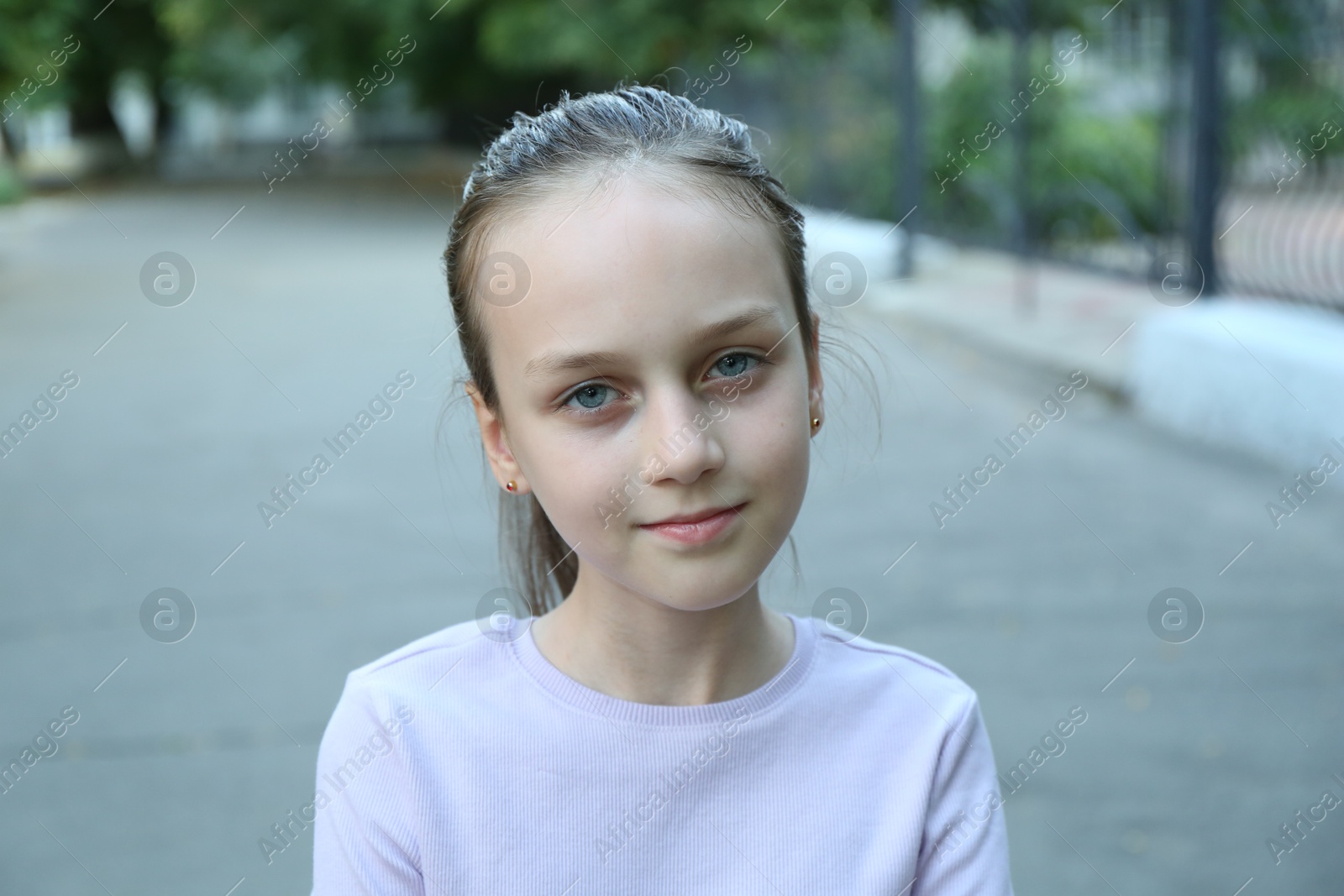 Photo of Portrait of cute little girl on city street