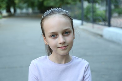 Photo of Portrait of cute little girl on city street