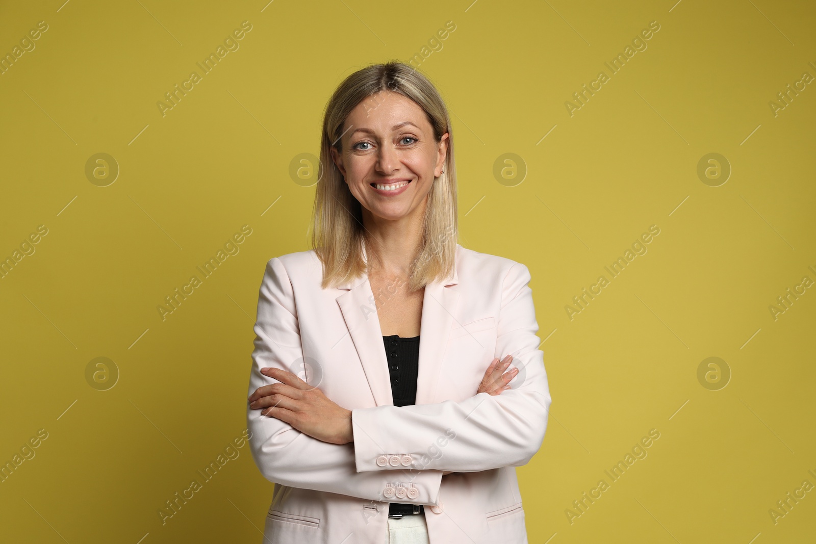 Photo of Portrait of beautiful smiling woman on yellow background