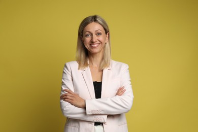 Portrait of beautiful smiling woman on yellow background