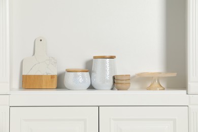 White shelving unit with different kitchenware indoors